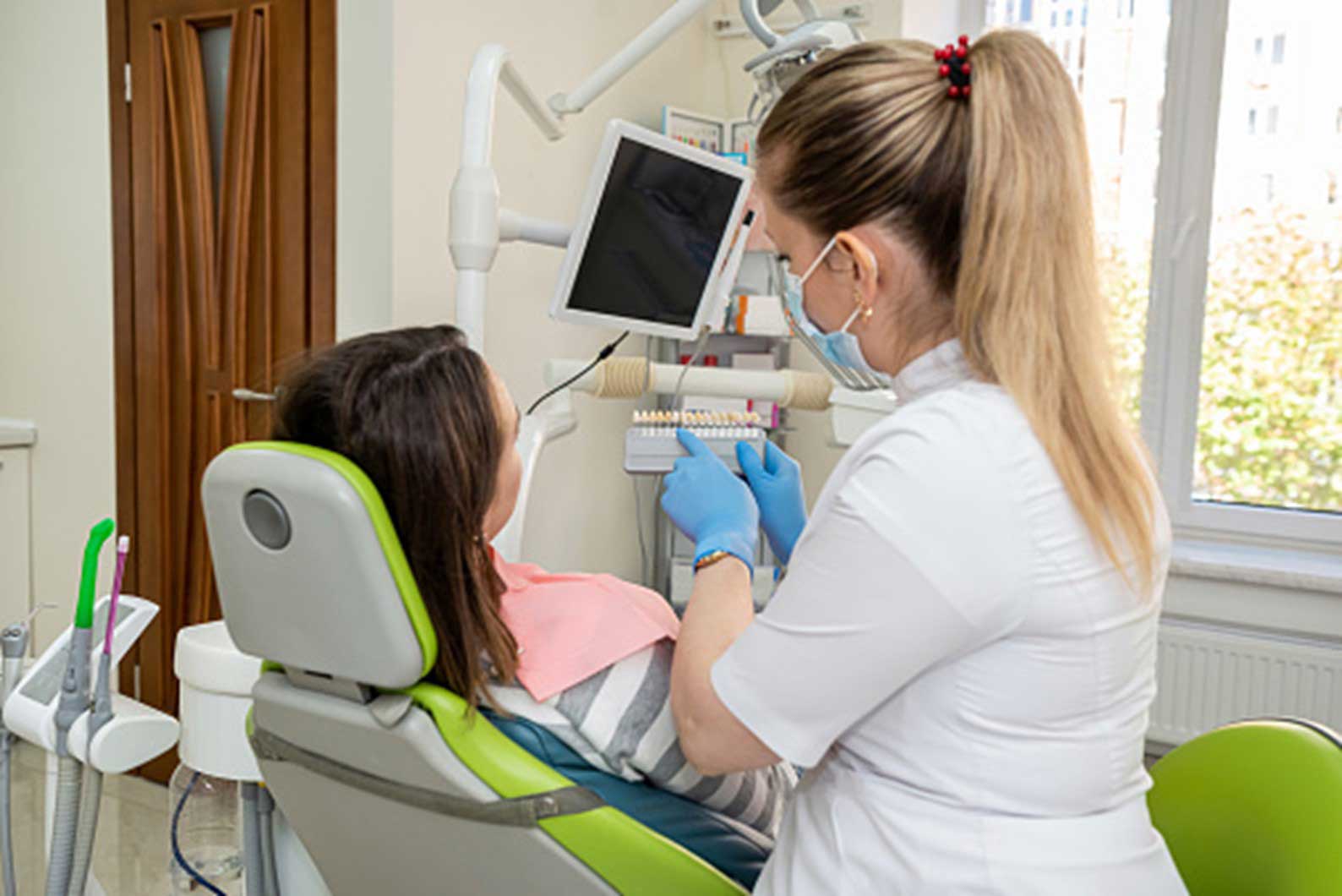 dentist performing a inspection in the mouth of a patient in a dentist's clinic